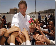 Prime-Minister Blair offers a hand to Basra children